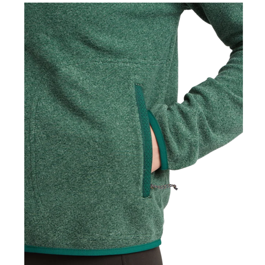 Close-up of a green heather fleece pullover jacket with a side zip pocket and a hand reaching into the pocket, on a white background.