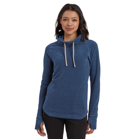 A woman modeling a heathered blue long-sleeve pullover hoodie with a high folded collar and light beige drawstrings, paired with black pants, against a solid white background.