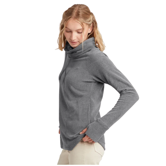 A woman viewed from the side wearing a heather gray long-sleeve top and light beige pants against a plain white background.