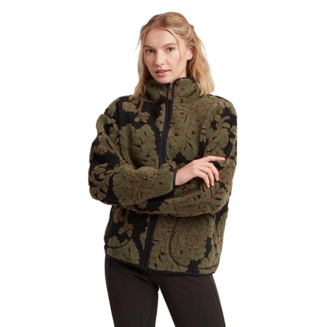 A woman shown from the front wearing a cropped, long-sleeve knit sweater with an intricate floral jacquard pattern in olive green and black, paired with black leggings, against a plain white background.