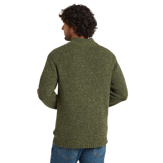 A man viewed from the back wearing a textured olive green knit sweater and blue jeans against a plain white background.