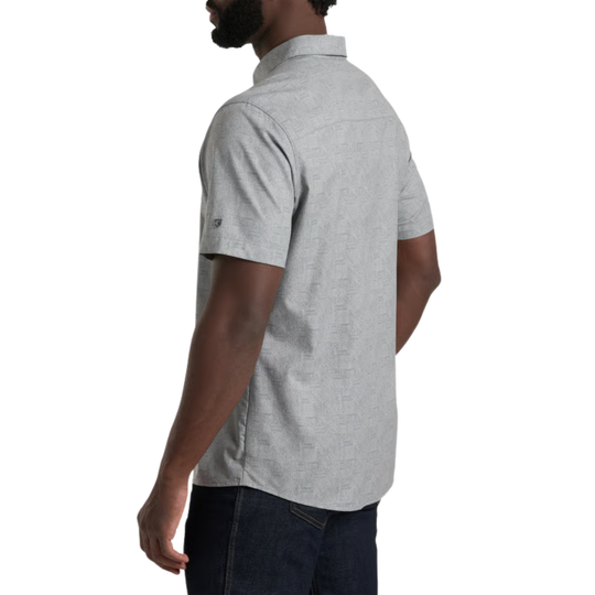Man wearing a gray short-sleeve button-up shirt on a white background