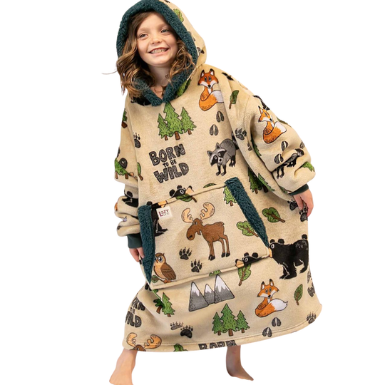 A hooded sweatshirt shown on a kid against a white background, featuring an all-over 'Born Wild' outdoor print with moose, bears, foxes, trees, mountains, and paw prints on a light beige base.