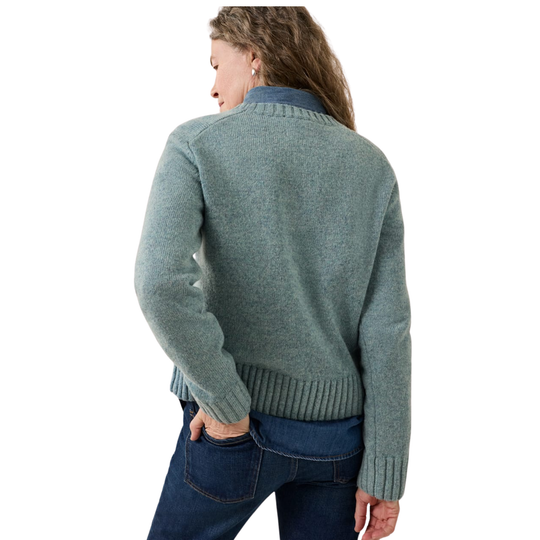 A woman shown from the back wearing a heathered sage green knit sweater with blue jeans, photographed against a plain white background.