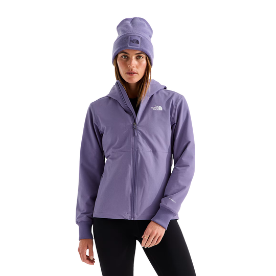 A woman wearing a light purple The North Face zip-up hooded jacket and a matching purple beanie, standing against a plain white background.