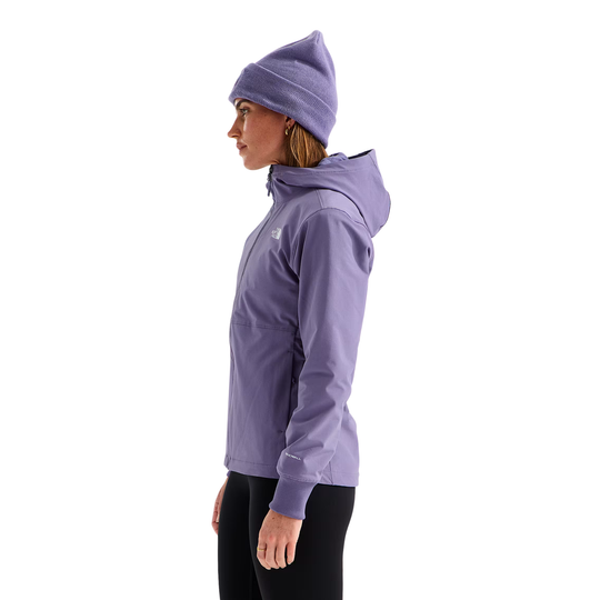 A woman in profile wearing a light purple hooded jacket, matching beanie, and black leggings against a plain white background.