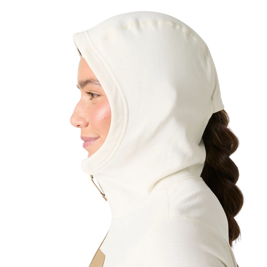 Woman wearing a beige hijab with a ponytail on a white background