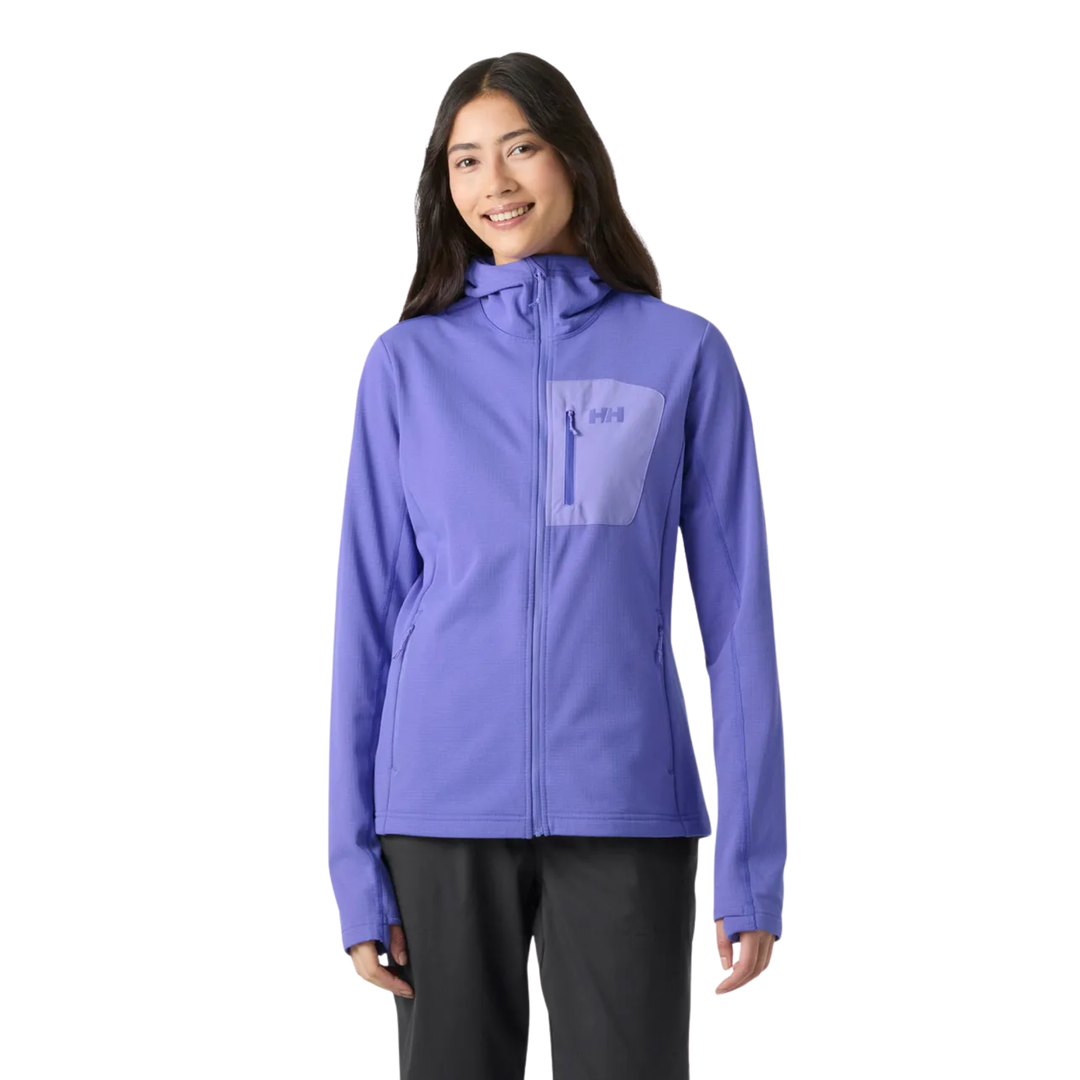A woman modeling a purple hooded zip-up jacket with a tonal chest pocket, paired with black pants, against a plain white background.