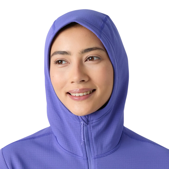 A woman wearing a purple full-zip hooded hijab against a solid white background.