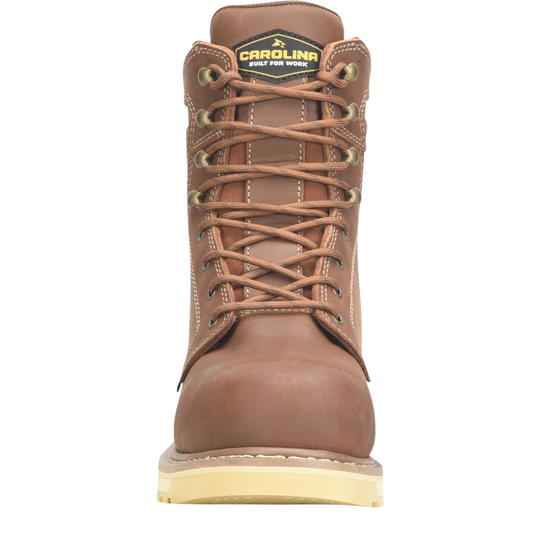 A brown leather work boot with tan laces, brass eyelets, and a light tan sole, shown from a front-facing perspective on a white background. The tongue label reads 'CAROLINA bOOT FOR WORK'.