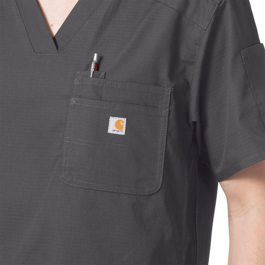 Dark gray V-neck scrub top with chest and sleeve pockets, shown close up