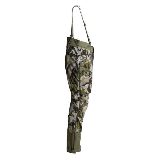 Side view of a pair of camouflage hunting waders with olive green trim and a metal hook-and-loop strap, shown against a plain white background.