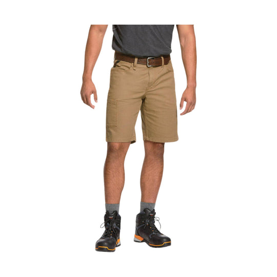Tan cargo shorts with belt loops and a side utility pocket, worn with black work boots