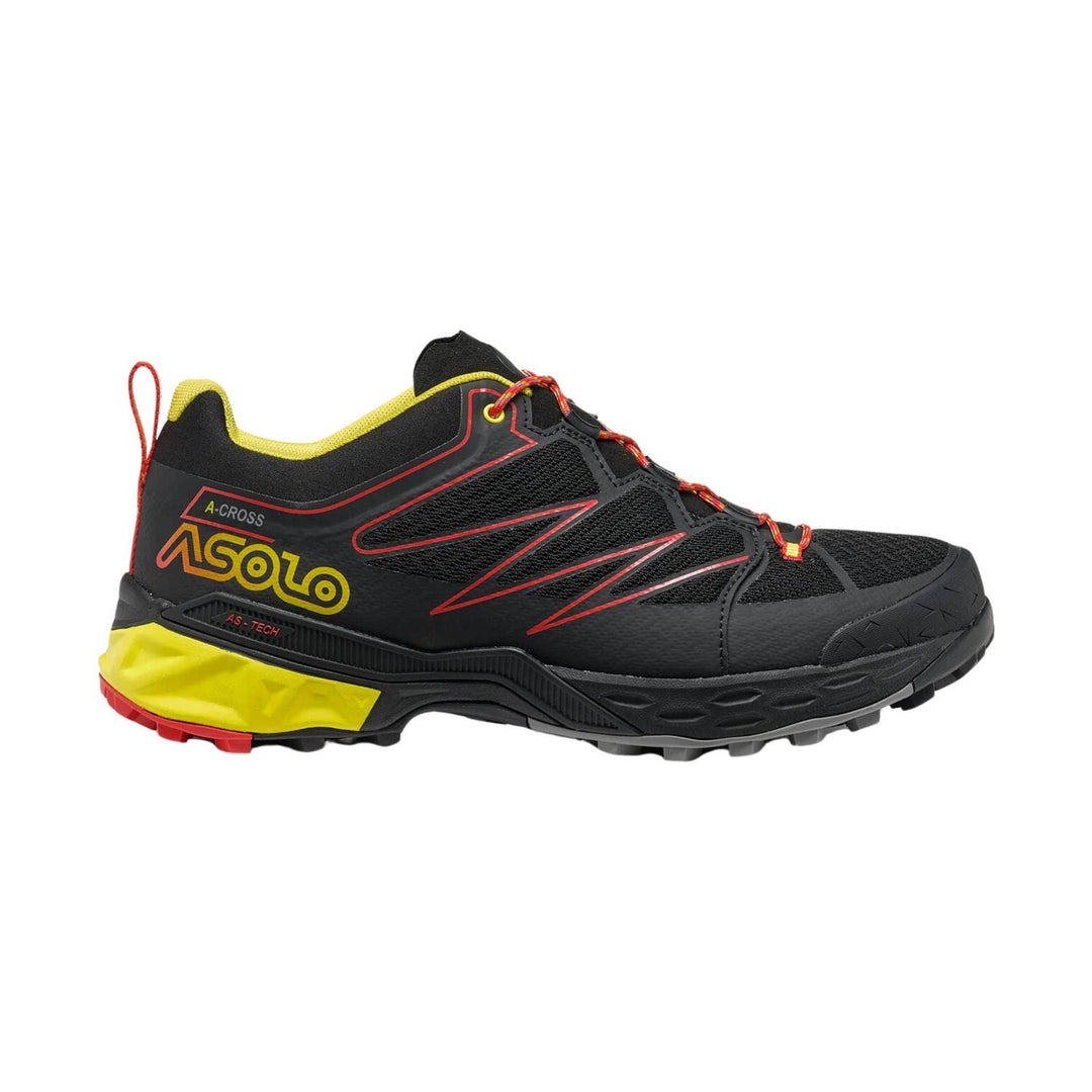 Black and yellow hiking shoe with red accents on a white background