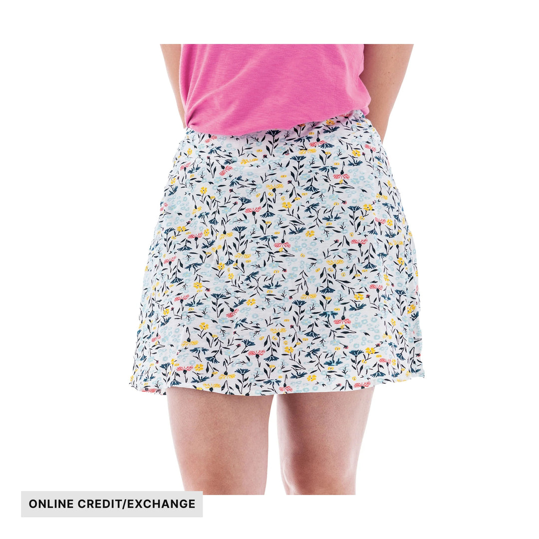 White floral print skort worn with a pink top, with ONLINE CREDIT/EXCHANGE text at the bottom