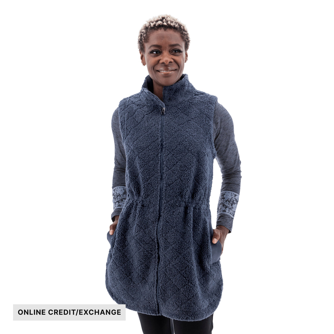 Navy fleece zip-front vest with high collar and side pockets, shown on a model, with "ONLINE CREDIT/EXCHANGE" text