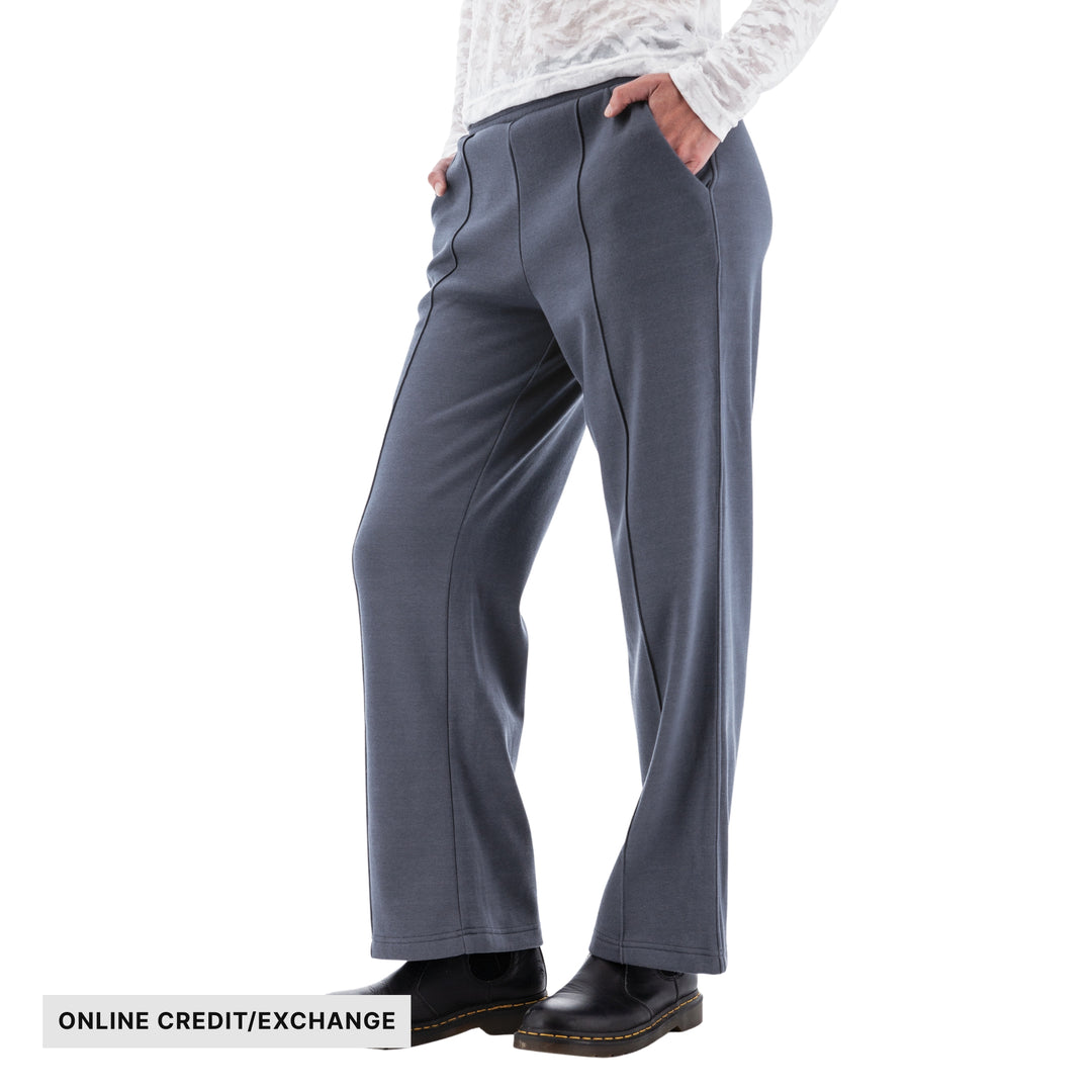 Gray wide-leg fleece pants on a model with visible “ONLINE CREDIT/EXCHANGE” text