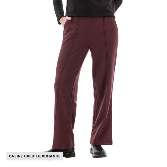 Maroon wide-leg fleece pants with visible seam detailing and online credit/exchange text