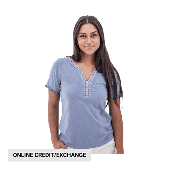 Light blue short-sleeve top with split neckline and decorative trim, shown on a model