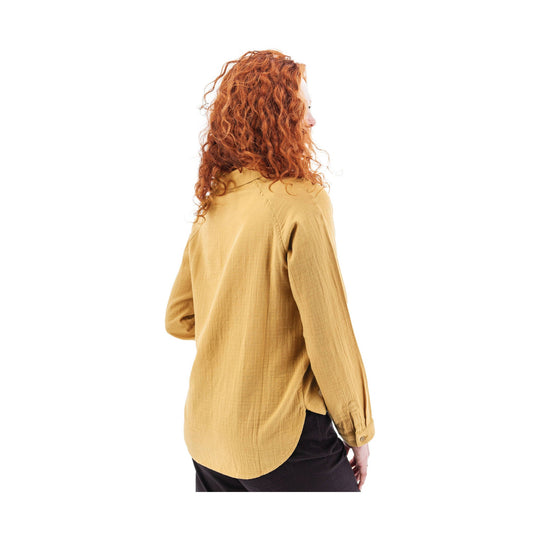 Mustard long-sleeve button-up top worn with black pants, shown from the back