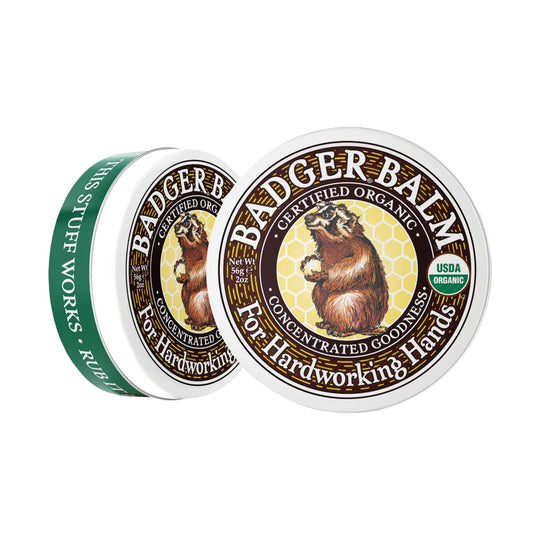 Two tins of hand balm, one front-facing and one side view, with bear label and USDA Organic seal