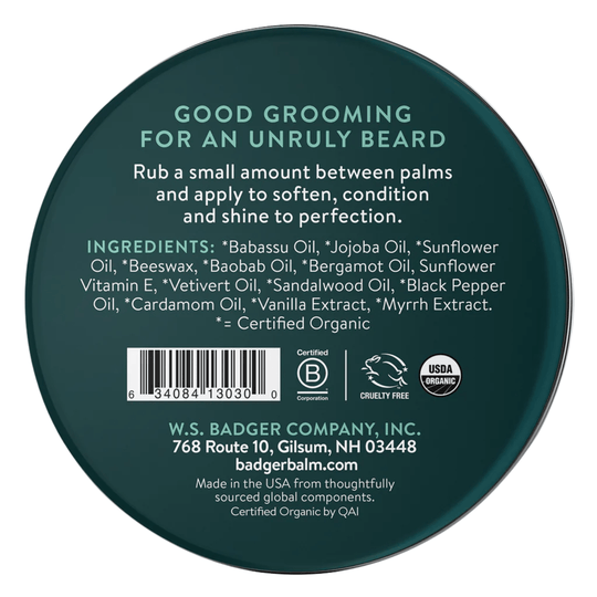 Dark green round tin lid with grooming instructions, ingredients, barcode, and USDA Organic and cruelty-free icons