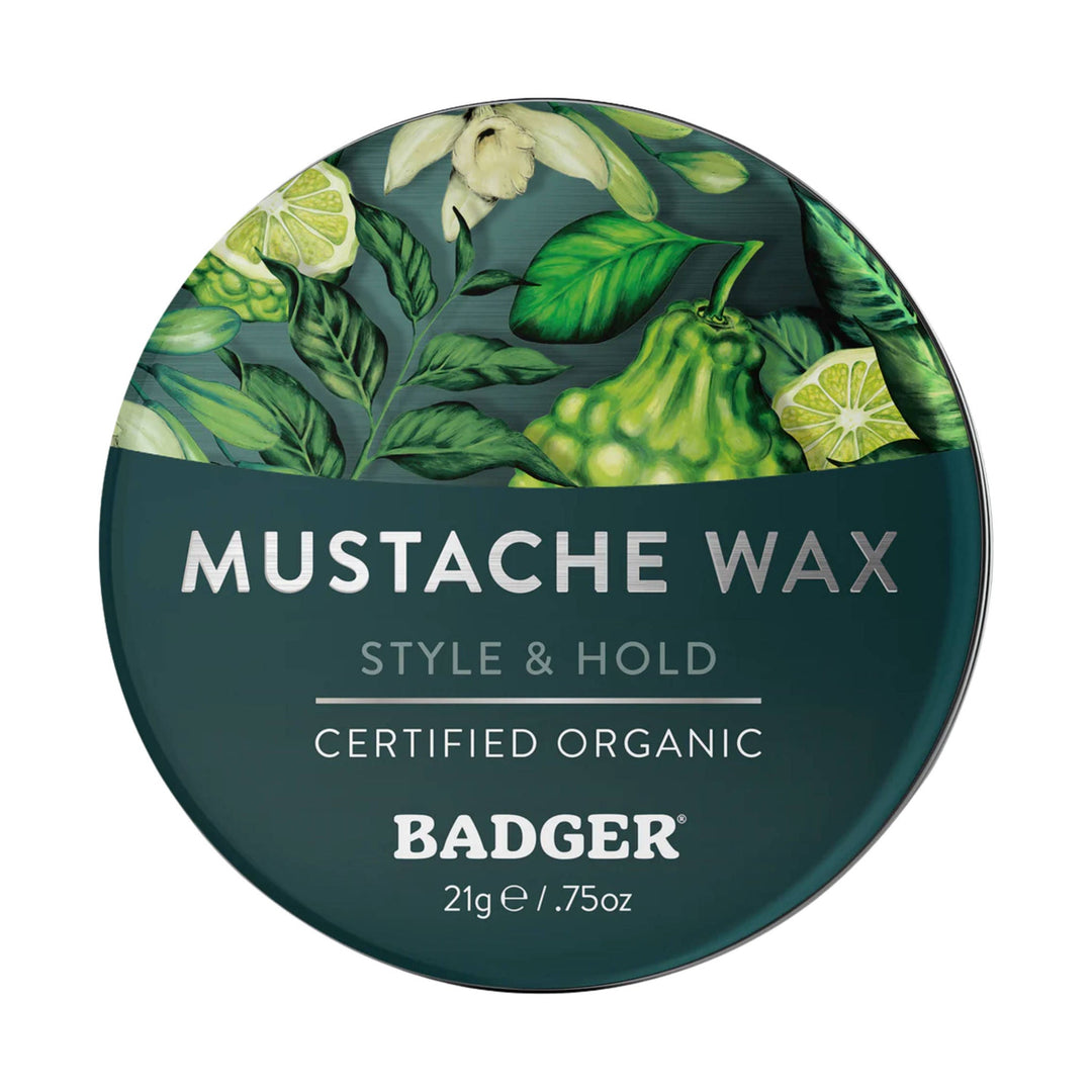 Round green tin of mustache wax with botanical graphics and text 'Mustache Wax' and 'Style & Hold'.