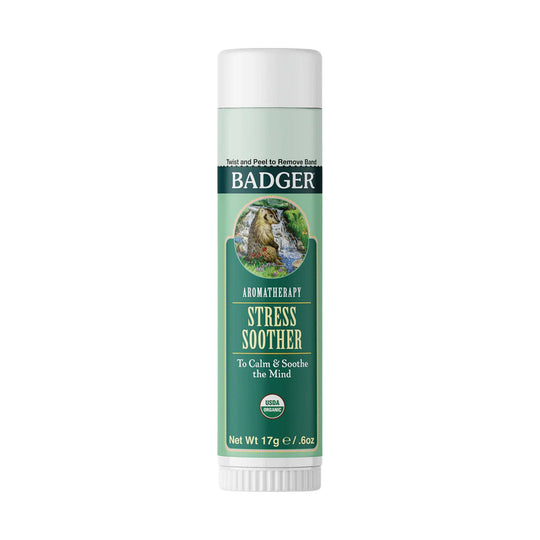 Green aromatherapy balm stick with white cap and woodland label