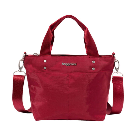 Small red tote bag with top handles, detachable shoulder strap, and front logo