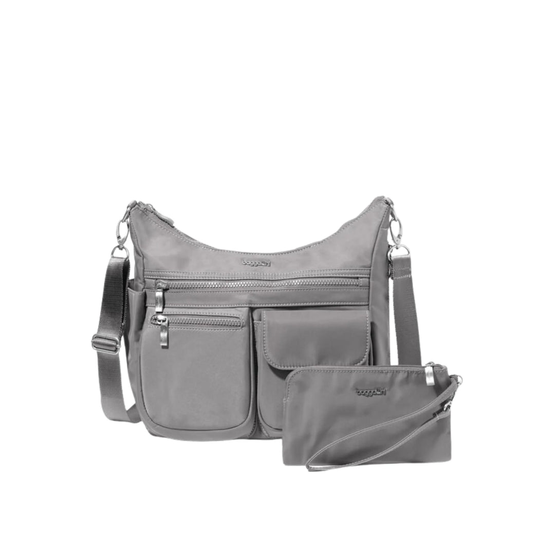 Gray crossbody bag with multiple front zip and flap pockets, shown with a matching wristlet pouch