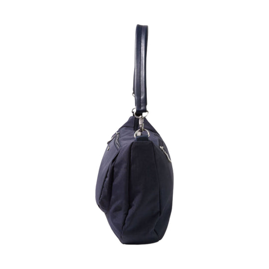 Navy half-moon shoulder bag with a top handle and silver hardware, shown from the side