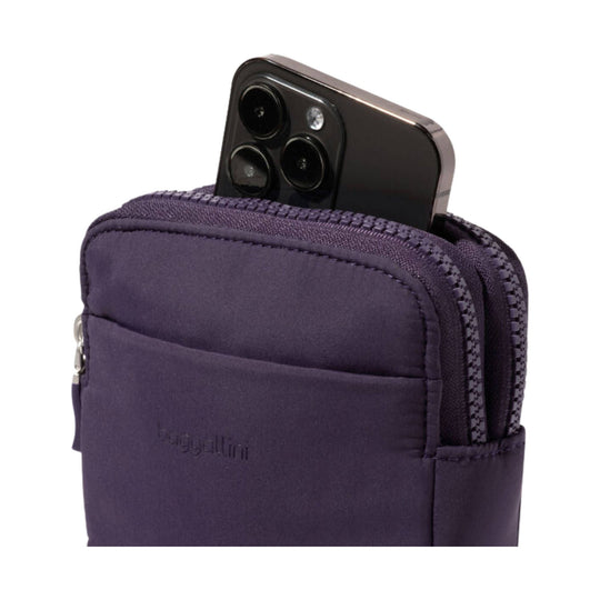 Purple zippered crossbody pouch holding a black smartphone