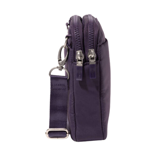 Compact purple crossbody bag shown from the side with two zippered compartments and an adjustable strap
