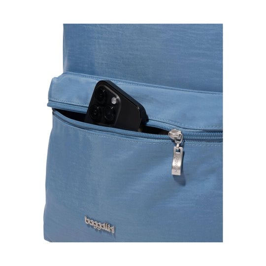 Blue backpack with a front zip pocket, a smartphone partly tucked into the pocket, and a metal zipper pull