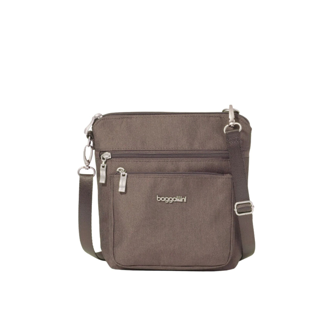 Brown crossbody bag with front zipper pockets and adjustable strap