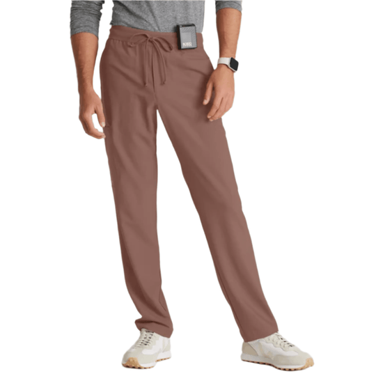 Brown straight-leg scrub pants with drawstring waist on a model