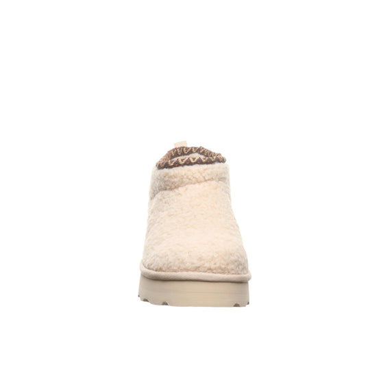 Cream faux-fur ankle boot with braided trim and beige lug sole, front view