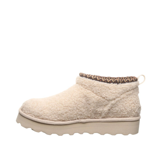 Cream fleece ankle boot with a thick beige platform sole and patterned collar trim