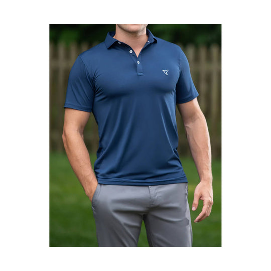 Navy short-sleeve polo shirt with a small chest logo, shown on a model with gray pants