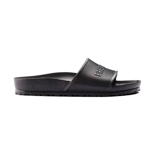 Black slide sandal with a textured strap, contoured footbed, and lugged sole