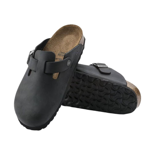 Black leather clog sandals with contoured cork footbeds, shown stacked at an angle