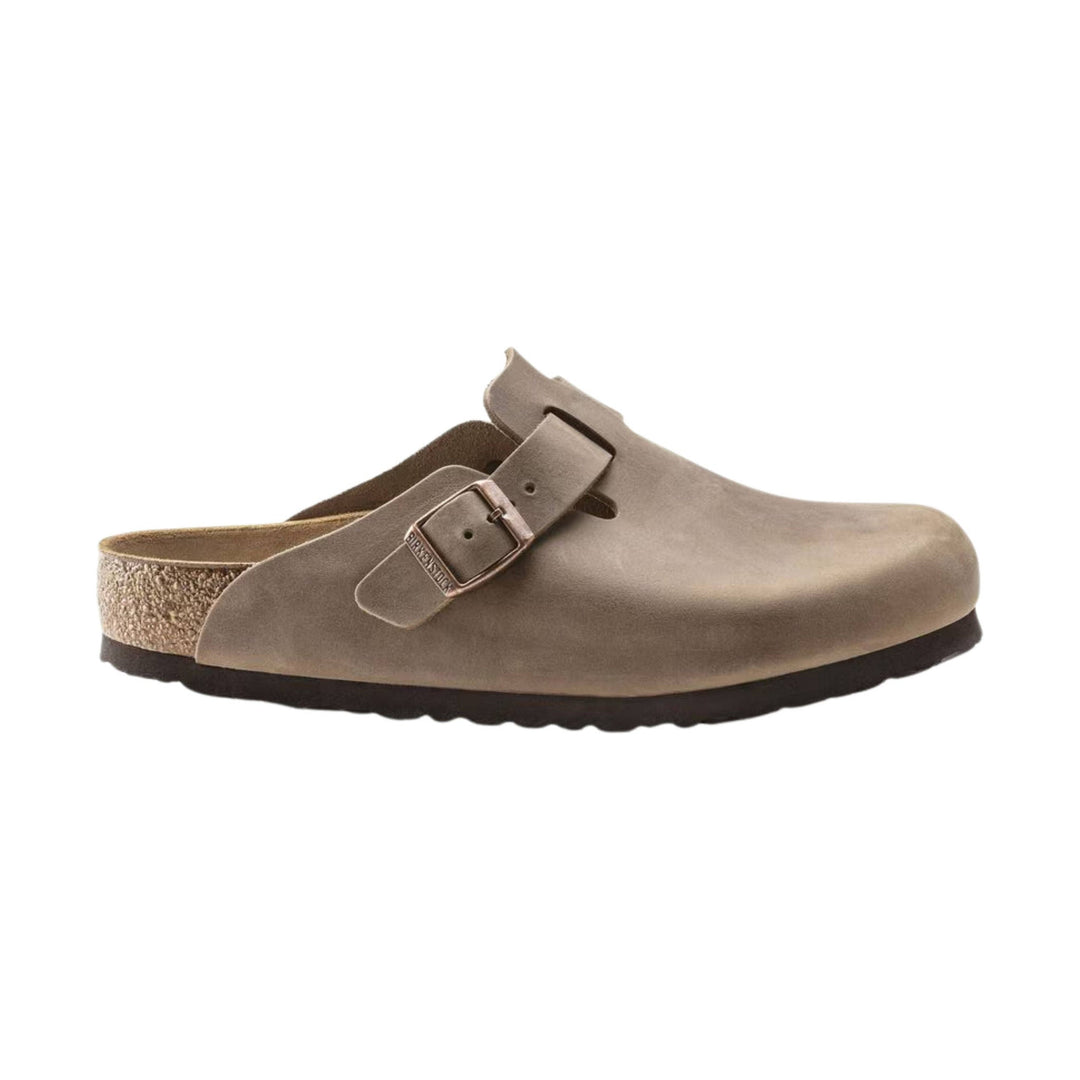 Taupe suede clog with an adjustable buckle strap and cork sole