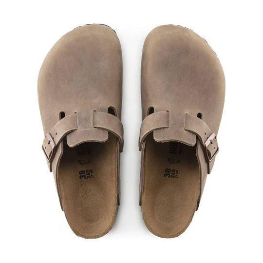 Pair of tan suede clogs with adjustable buckle straps, top view