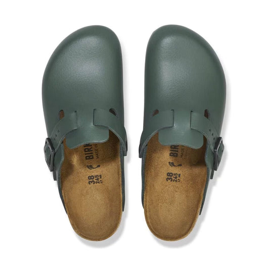 Green leather clog-style sandals with closed toes and side buckles