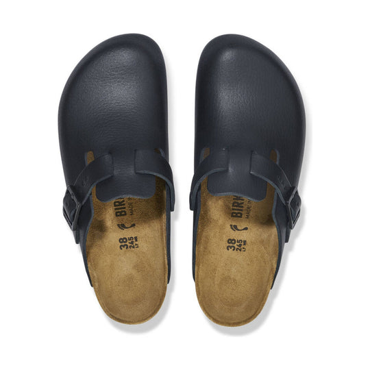 Black closed-toe clogs with buckle straps, top view