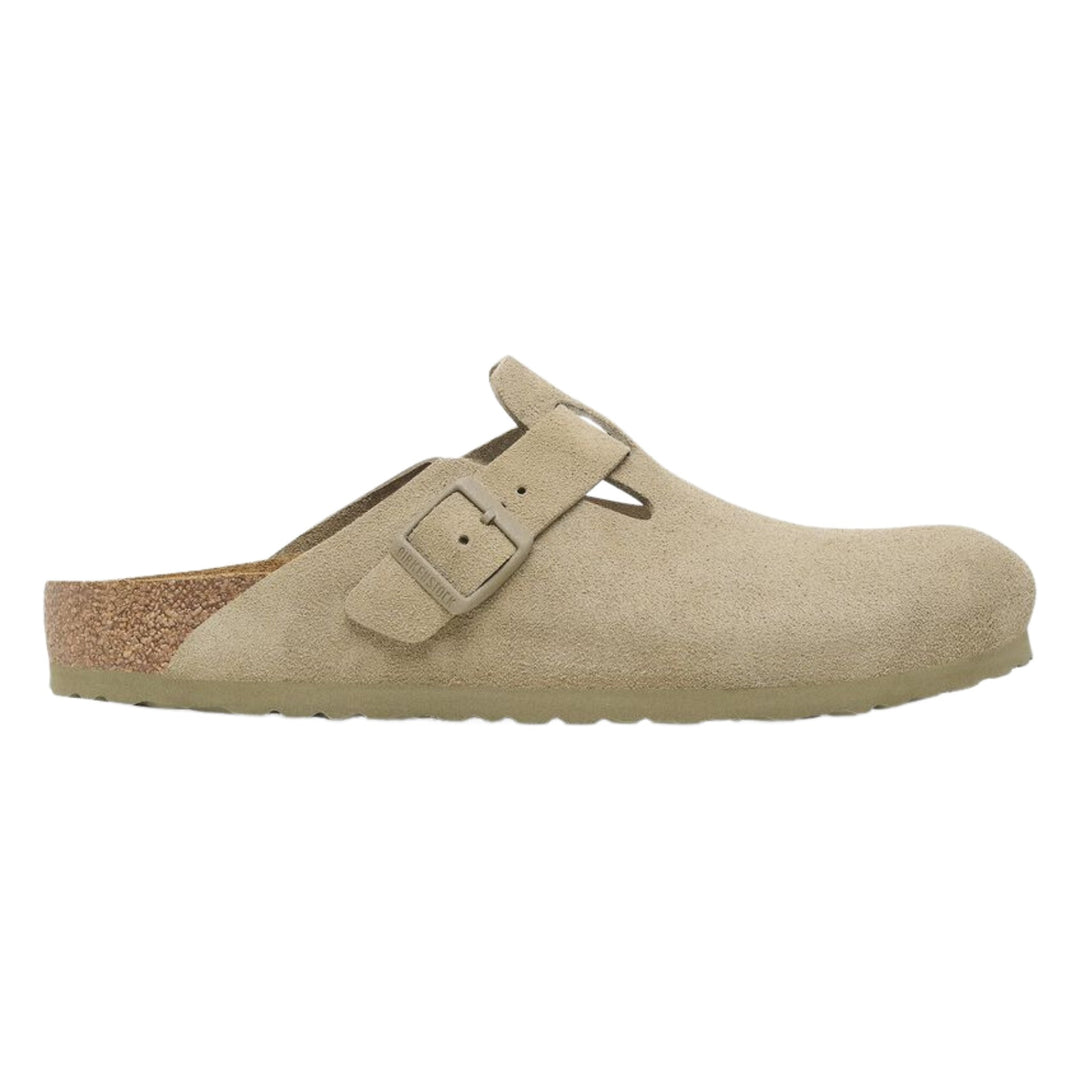 Beige suede clog with a single buckle strap and cork heel cup, side view