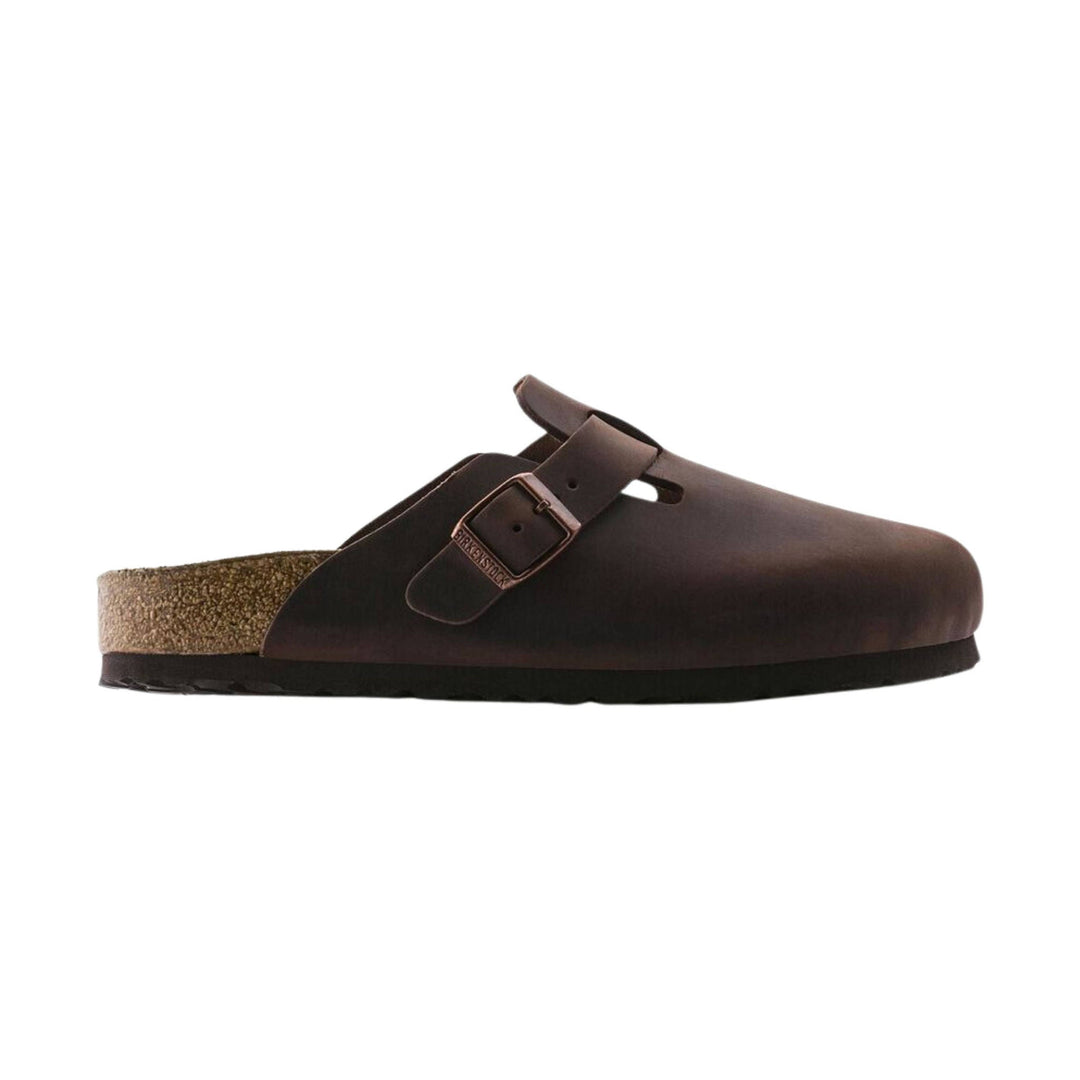 Brown leather clog with a single buckle, cork footbed, and black sole, shown in side view