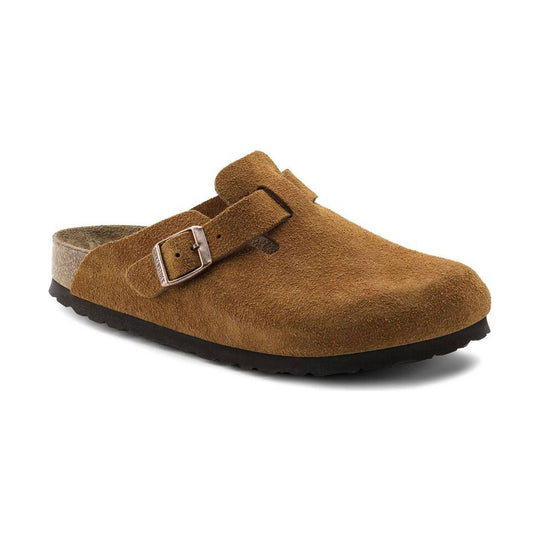 Brown suede clog with a single buckle strap, cork heel rim, and black treaded sole
