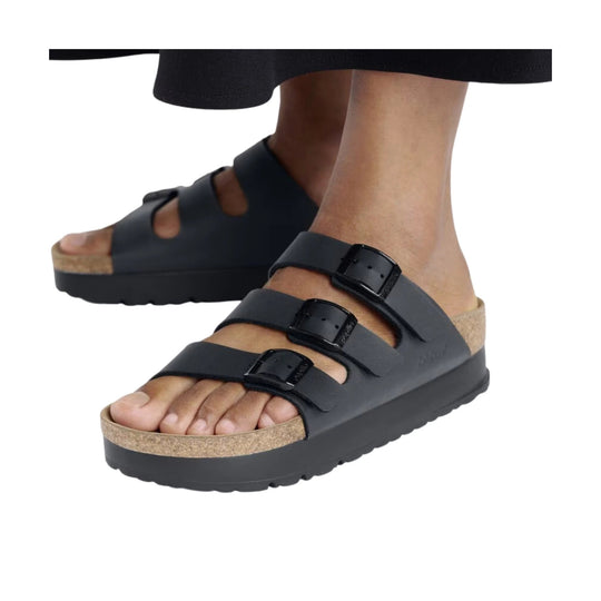 Black platform sandal with three buckle straps and cork-look footbed