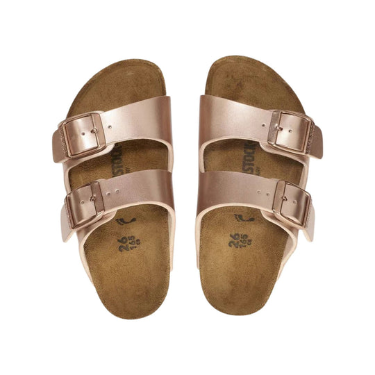 Rose-gold double-buckle slide sandals with cork footbeds, shown from above.
